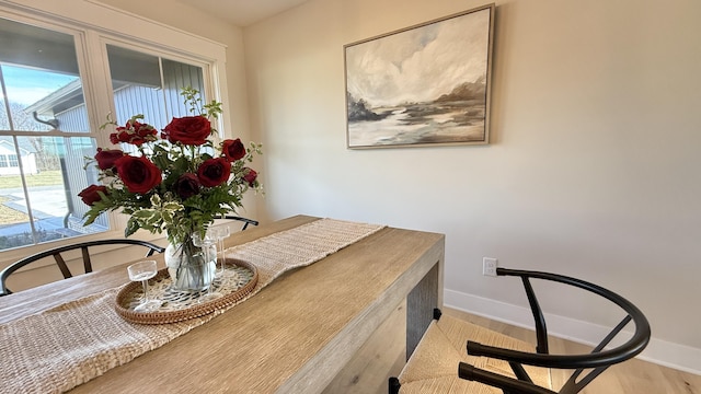 dining room with light wood-style floors and baseboards