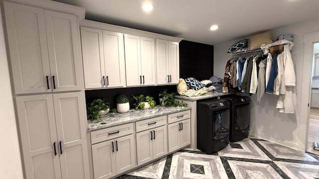 interior space with independent washer and dryer, cabinet space, and recessed lighting