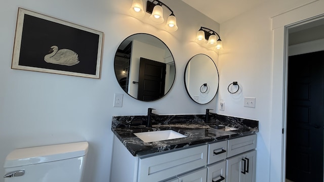 bathroom with toilet and vanity