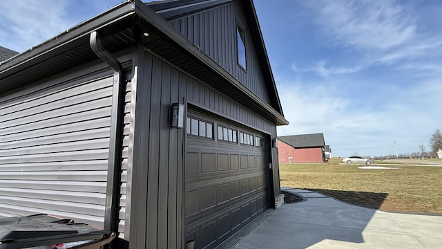 view of property exterior featuring a garage and a yard