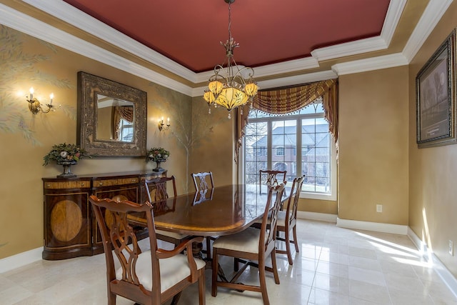 dining space featuring a notable chandelier, a tray ceiling, ornamental molding, and baseboards