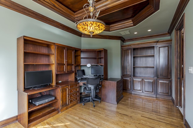 office space featuring a tray ceiling, visible vents, light wood-style floors, ornamental molding, and a chandelier