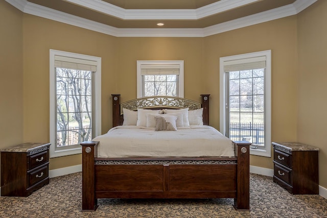 bedroom with ornamental molding, dark carpet, and baseboards