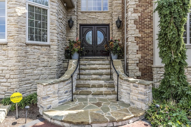 doorway to property with stone siding