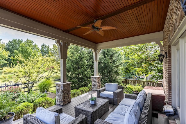 view of patio / terrace with an outdoor hangout area, fence, and a ceiling fan