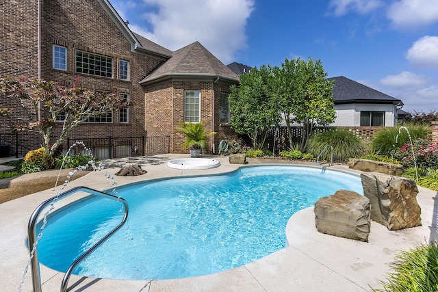 view of pool featuring a fenced in pool, fence, a patio, and an in ground hot tub