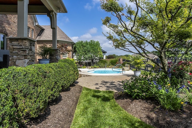 view of swimming pool with a patio area, fence, and a fenced in pool