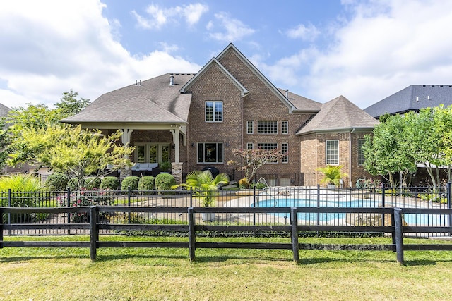 view of swimming pool featuring a yard, fence, and a fenced in pool