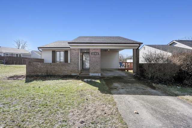 bungalow-style house featuring entry steps, a shingled roof, fence, a front yard, and brick siding