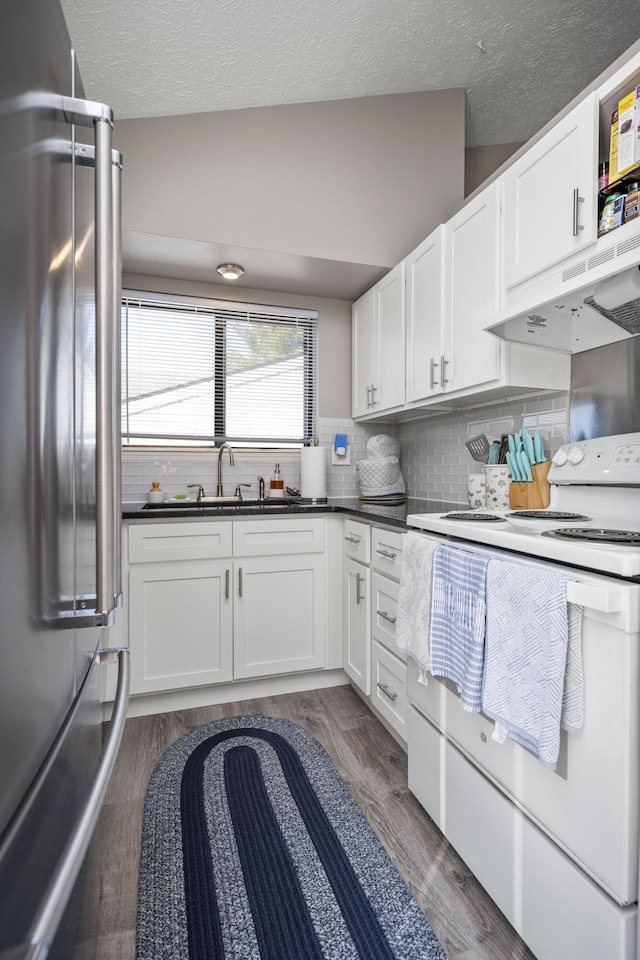 kitchen with dark wood-style flooring, white electric range oven, a sink, under cabinet range hood, and high end refrigerator