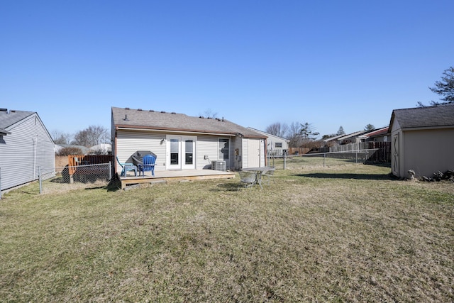 back of house with a fenced backyard, central AC, a deck, and a lawn