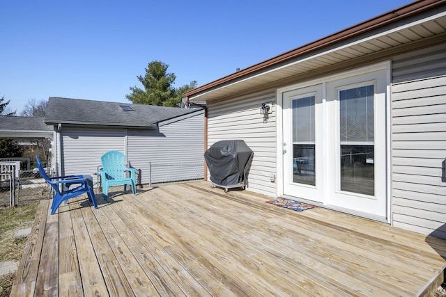 wooden deck with a grill