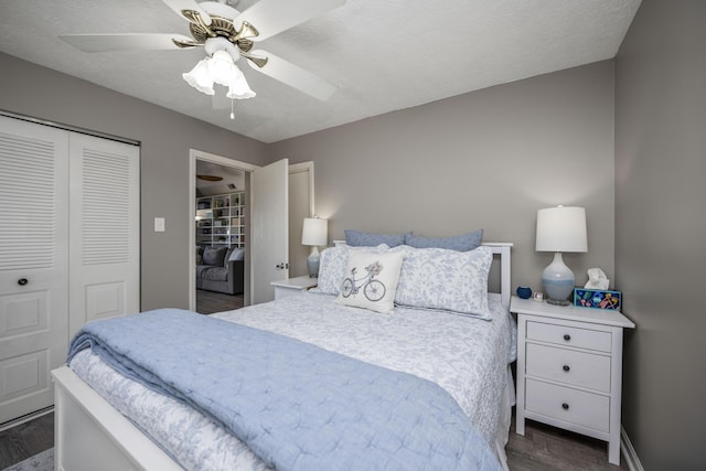 bedroom with baseboards, a ceiling fan, wood finished floors, a textured ceiling, and a closet