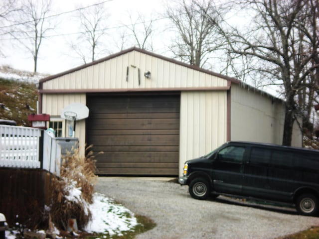 detached garage with gravel driveway