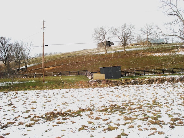 view of yard featuring a rural view and fence