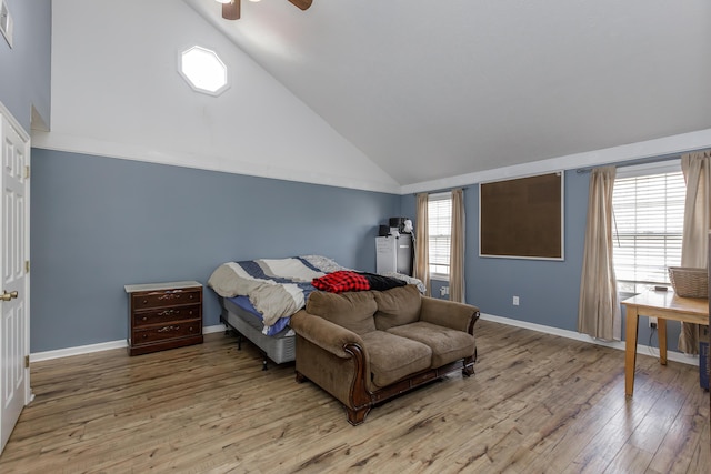 bedroom with light wood finished floors, multiple windows, and baseboards