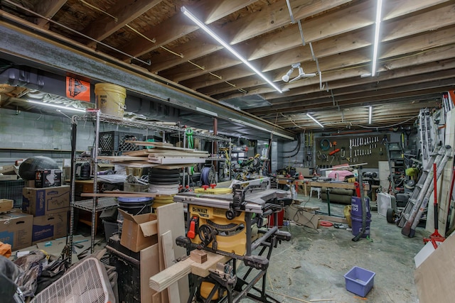 unfinished basement featuring a workshop area