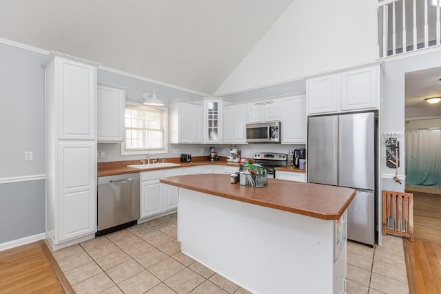 kitchen featuring white cabinetry, a kitchen island, and appliances with stainless steel finishes