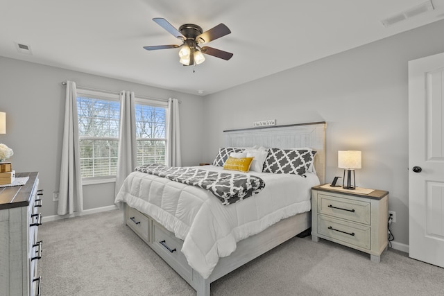 bedroom featuring a ceiling fan, visible vents, light carpet, and baseboards