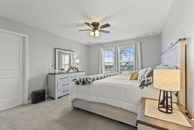 bedroom featuring a ceiling fan and light colored carpet