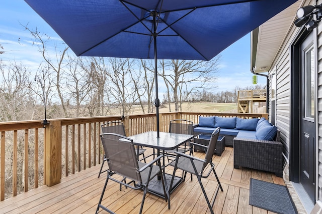 wooden deck featuring outdoor lounge area and outdoor dining space