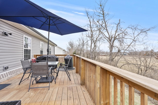 wooden terrace featuring outdoor dining space