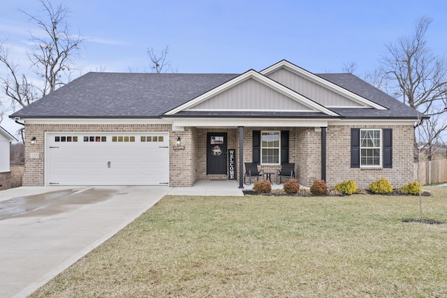 view of front of house featuring a porch, a garage, brick siding, concrete driveway, and a front yard