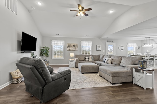 living area featuring dark wood-style floors, visible vents, and a healthy amount of sunlight