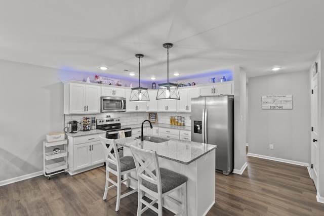 kitchen with stainless steel appliances, white cabinets, and a sink