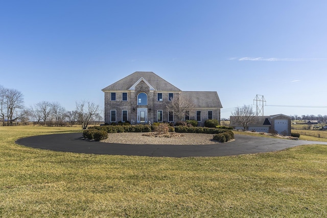 view of front of property with stone siding and a front yard