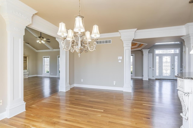 unfurnished dining area featuring light wood-style flooring, ornamental molding, ceiling fan with notable chandelier, and visible vents