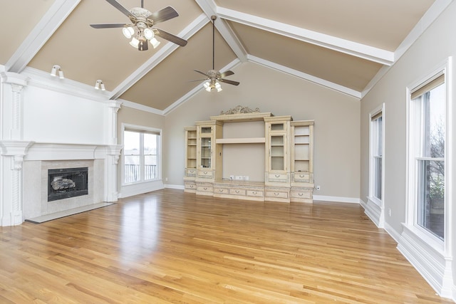 unfurnished living room with light wood-style flooring, baseboards, beam ceiling, a ceiling fan, and a fireplace