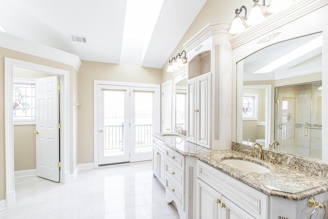 bathroom featuring double vanity, a sink, a stall shower, and visible vents