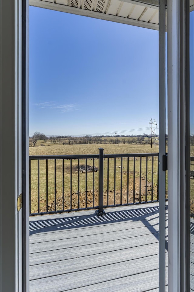 wooden deck featuring a rural view