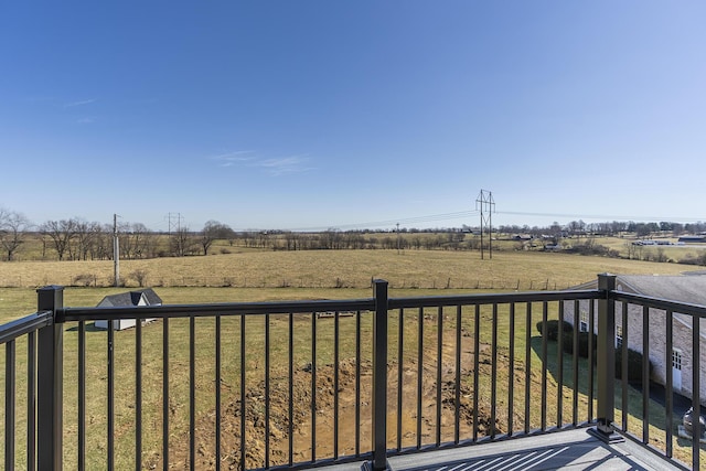 wooden terrace with a lawn and a rural view