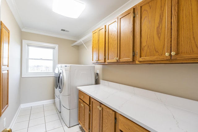 laundry area featuring light tile patterned flooring, washer and clothes dryer, crown molding, visible vents, and cabinet space