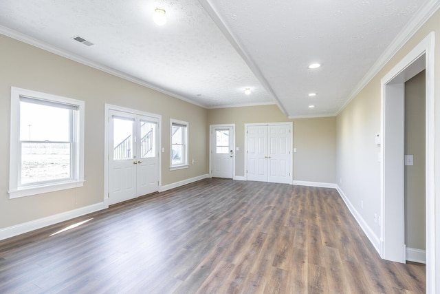 foyer featuring dark wood-style flooring, crown molding, baseboards, and visible vents
