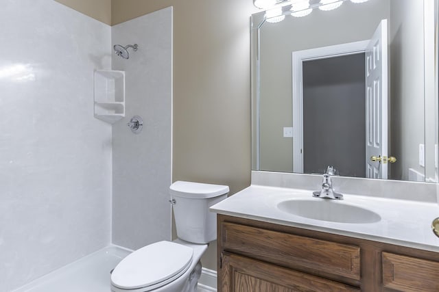 bathroom featuring a shower, toilet, and vanity