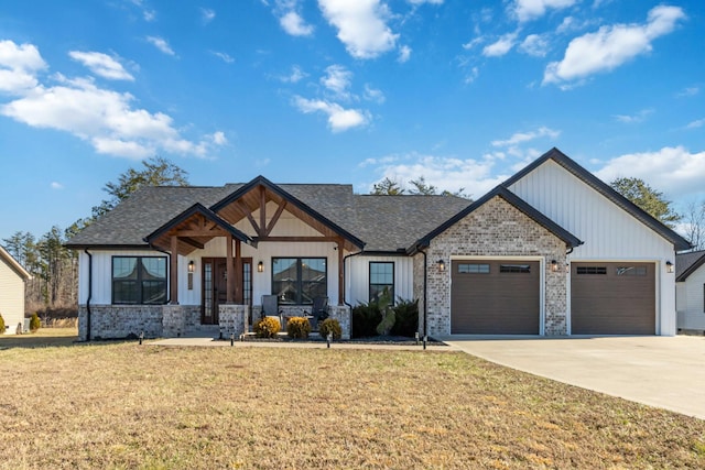 modern farmhouse style home with an attached garage, concrete driveway, brick siding, and a front yard