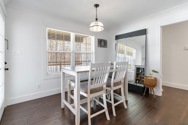 dining area with dark wood-style floors, a healthy amount of sunlight, and baseboards