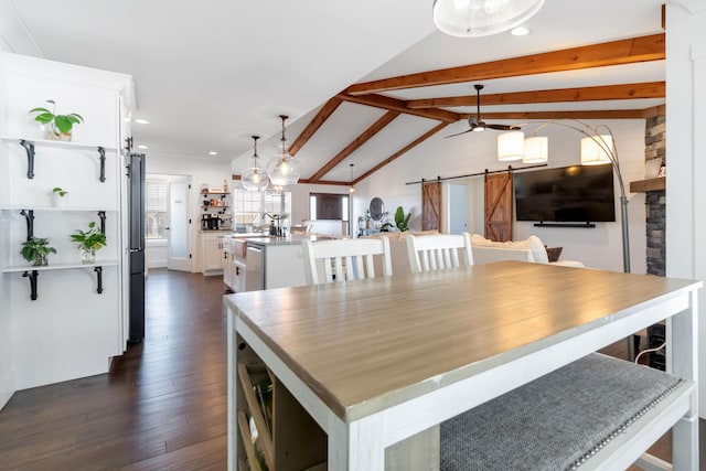 dining area featuring lofted ceiling with beams, a barn door, dark wood-style floors, and recessed lighting