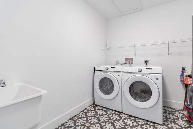 clothes washing area featuring laundry area, separate washer and dryer, light floors, and baseboards