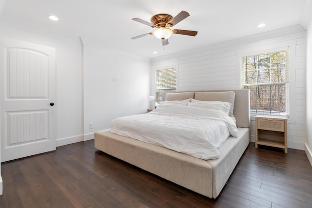 bedroom featuring baseboards, ornamental molding, and dark wood finished floors