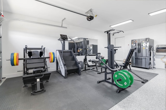 workout room with a garage, heating unit, and baseboards