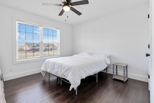 bedroom featuring ceiling fan, dark wood-style flooring, and baseboards