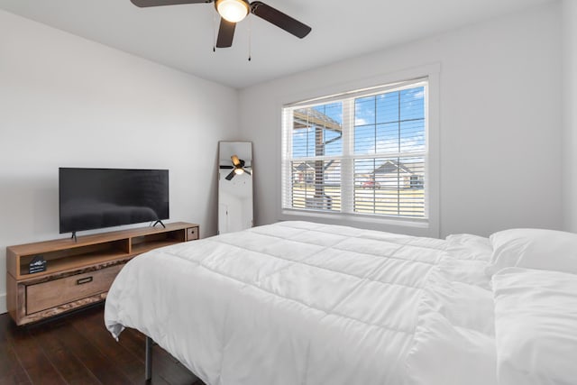 bedroom with dark wood-style floors and a ceiling fan