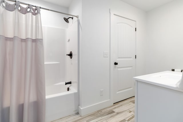 full bathroom featuring shower / bath combo, wood finished floors, and vanity