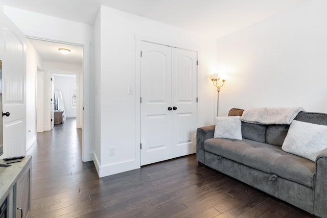 living room featuring dark wood-style floors and baseboards