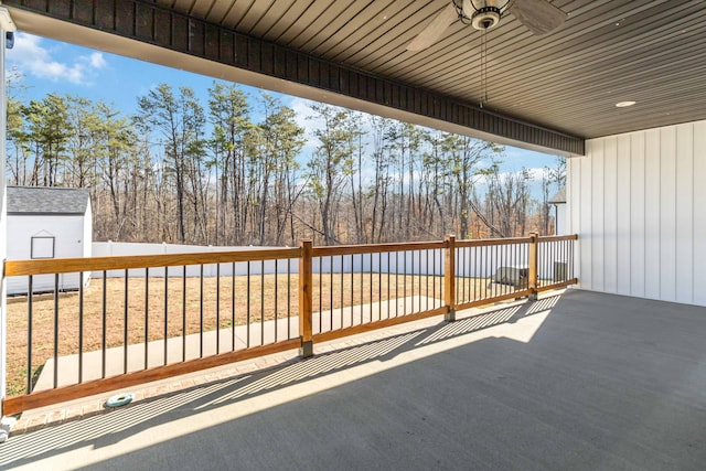 wooden terrace with a fenced backyard and a ceiling fan