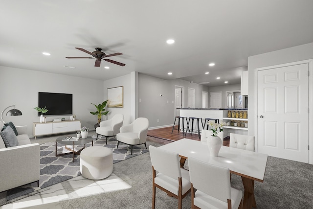 living room featuring ceiling fan, baseboards, and recessed lighting